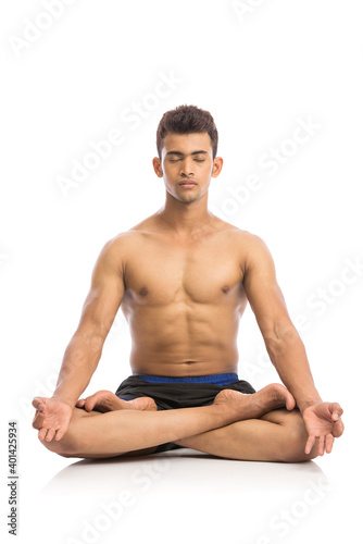 Young man is doing yoga isolated over white background