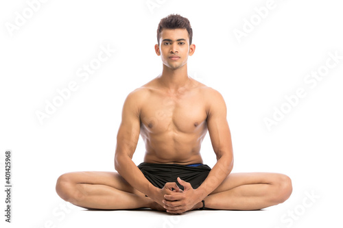 Young man is doing yoga isolated over white background