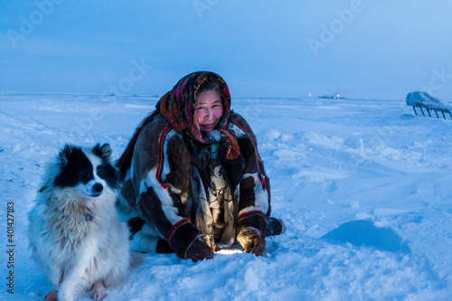 Photography A woman, in the national winter clothes of the northern inhabitants of the tundr