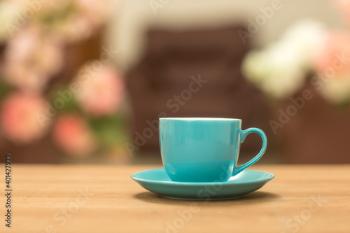 Teal tea cups on table at home.