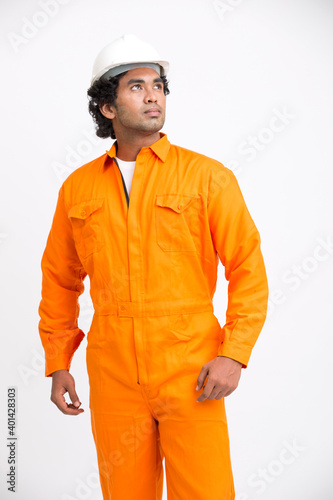 Indian municipal young worker standing with safety helmet on white background. photo