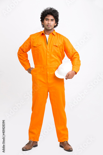 Indian municipal young worker with safety helmet on white background. photo
