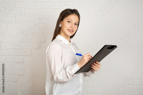 beautiful young female with a folder in her hands on a white background