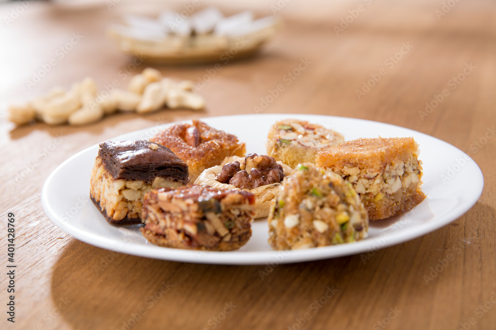 Plates of Oriental sweets on table.