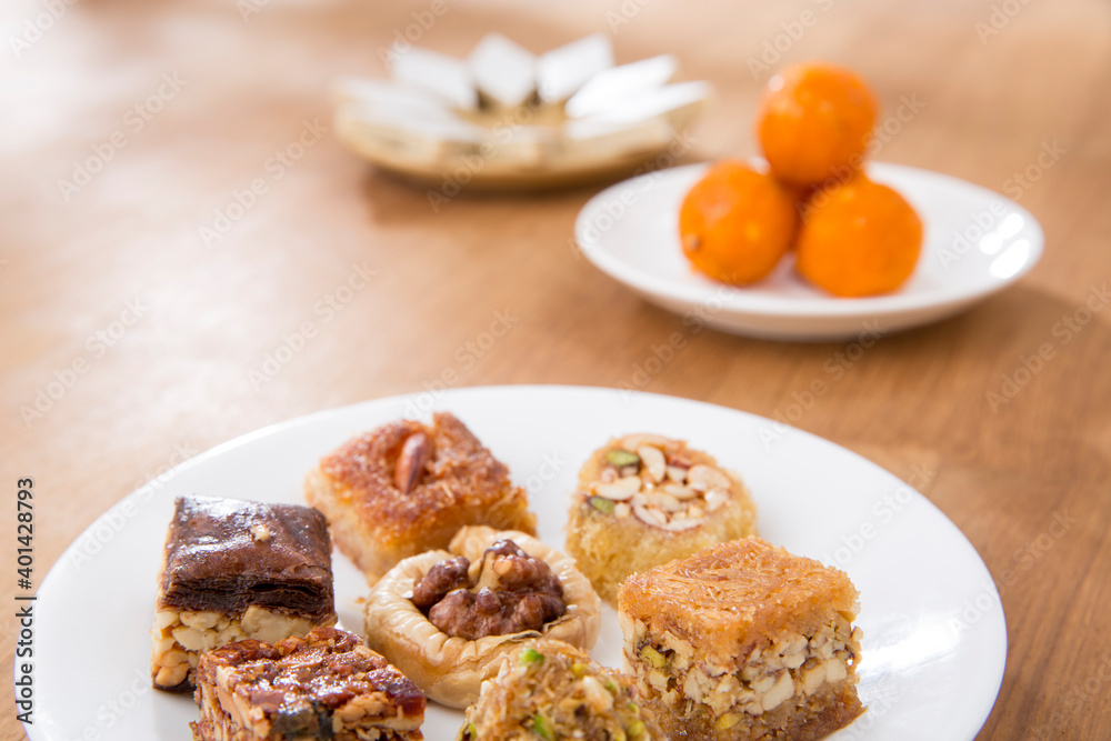 Plates of Oriental sweets on table.