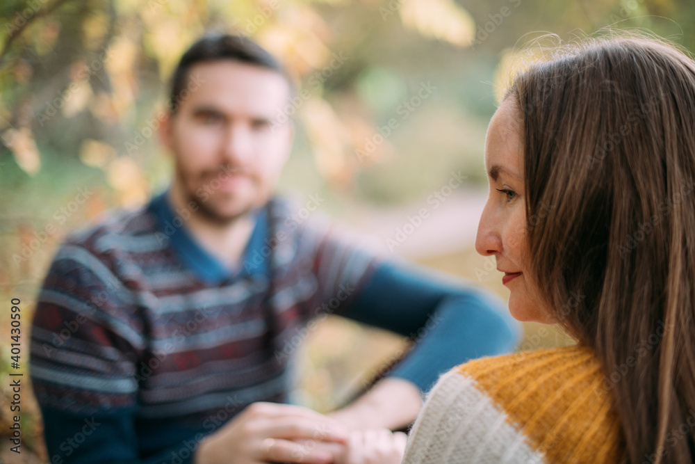 A romantic date, a walk in nature. Young couple of lovers together on the lake in early autumn A romantic date, a walk in nature. Young couple of lovers together on the lake in early autumn