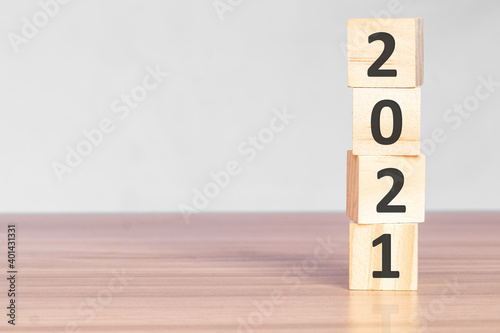 Wooden blocks stack with numbers 2021 The beginning of the new year on the table. Happy New Year and holiday concept.