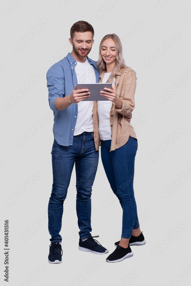 Couple Watching in Tablet Standing Isolated. Commecial, Shpping, Advertisment Concept Couple Watching in Tablet Standing Isolated. Commecial, Shpping, Advertisment Concept