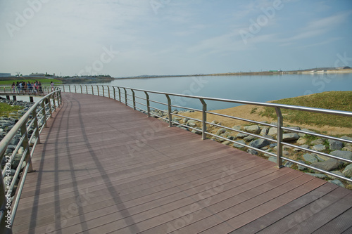 Fototapeta Naklejka Na Ścianę i Meble -  Boyukshor Lake in Baku Azerbaijan . According to geological data, the average depth of the water in the lake is 3.40-3.95 meters . An oval bridge from iron and wood on the edge of the lake .