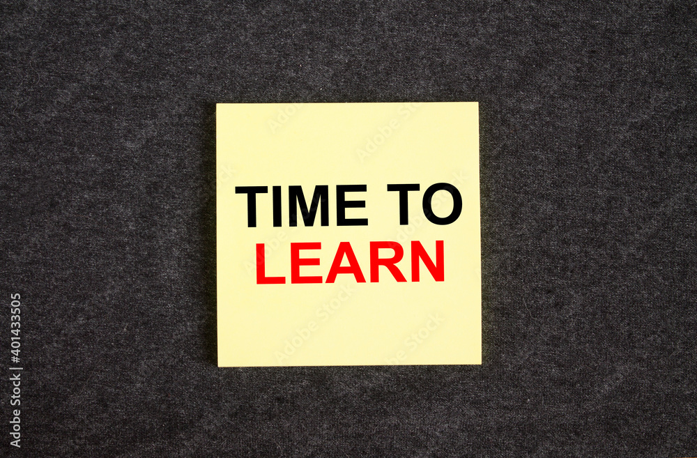 Yellow sticker on the dark gray texture background with text Time To Learn Yellow sticker on the dark gray texture background with text Time To Learn