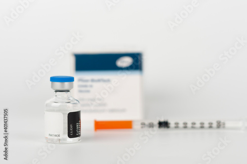 Medical concept, syringe with needle, vial and paper box with Covid-19 Vaccines photo