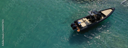 Aerial drone ultra wide photo of inflatable rib power boat anchored in tropical exotic emerald crystal clear sea bay