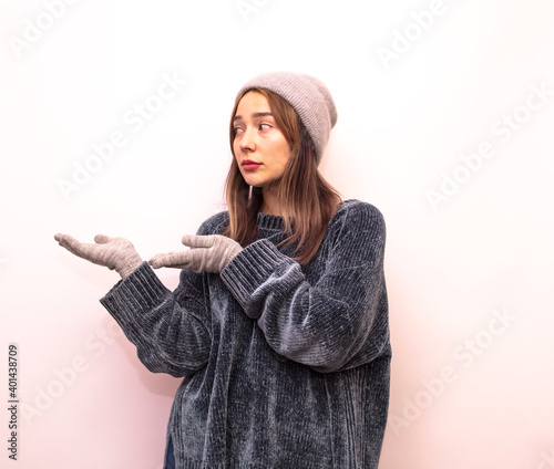 Girl in grey clothes shows the inscription isolated on white background