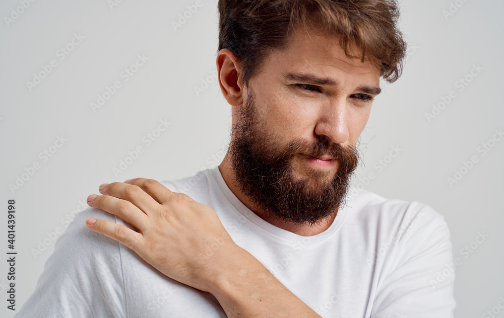 Obraz premium bearded man touching shoulder with hand pain dislocation