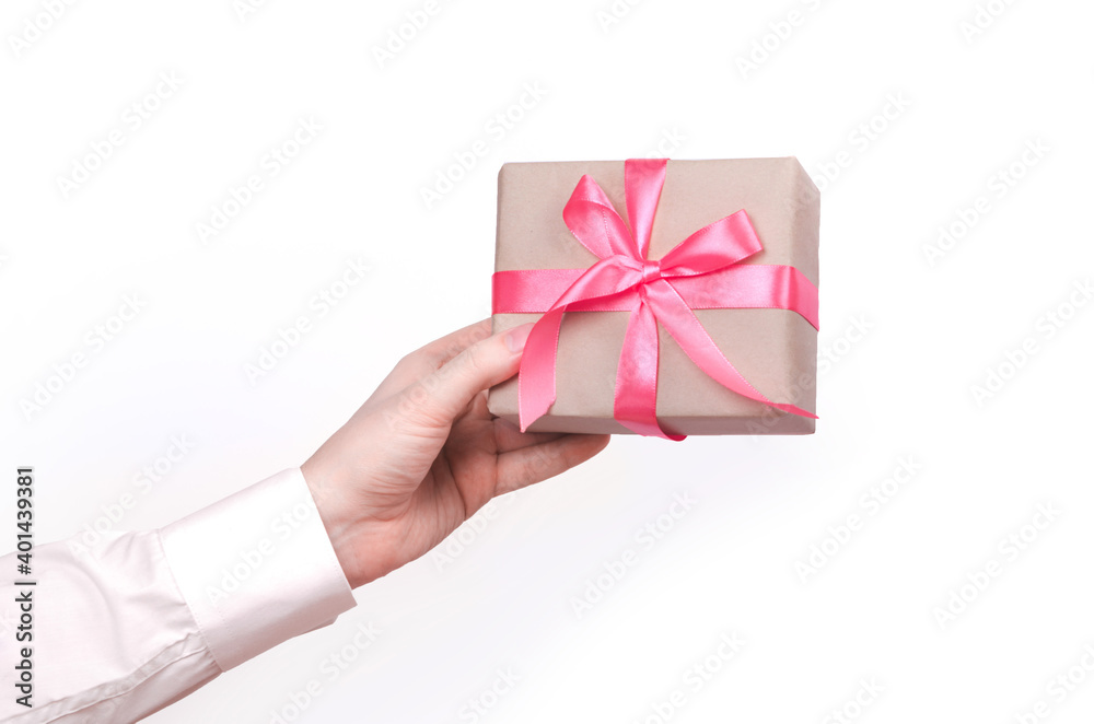 Gift box with pink ribbon in male hand Gift box with pink ribbon in male hand