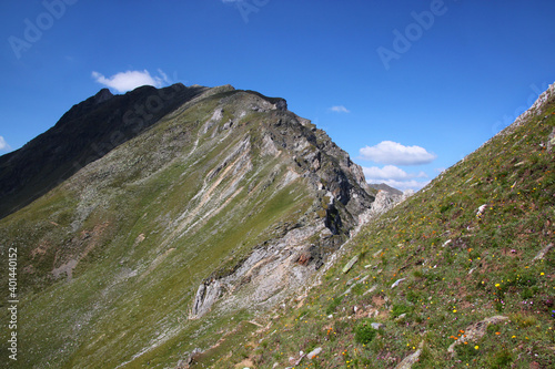 Göflaner Schartl pass and rock formations on a mountain ridge at a hiking trail in the South Tyrol Alps seen from the Martell valley 