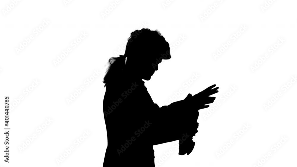 Silhouette Man dressed like Mozart conducting while walking.