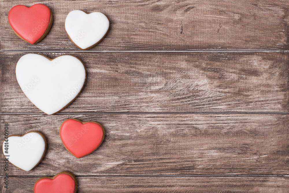 Fototapeta premium Top flat lay close up view photo of yummy tasty cookies in shape of hearts on brown rustic background