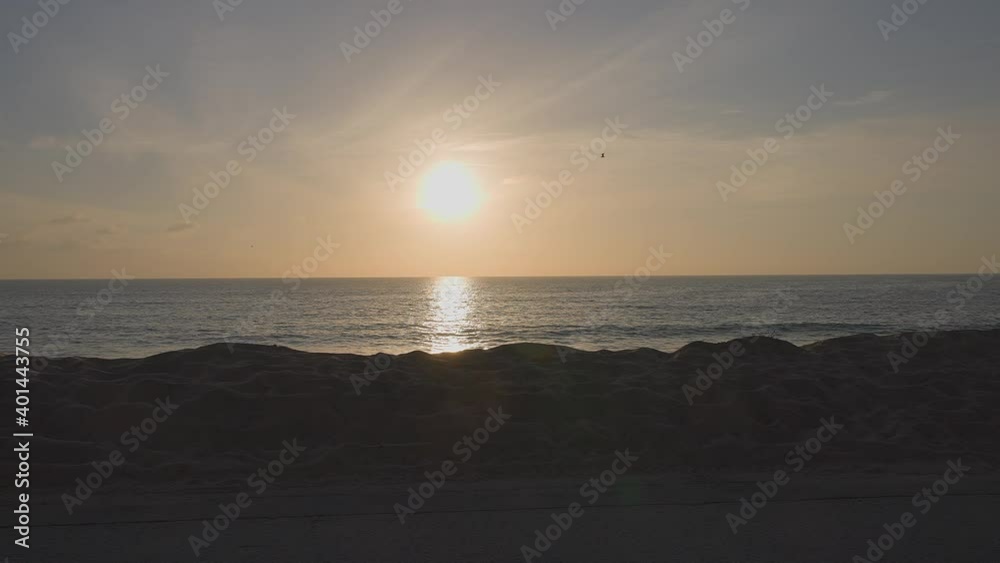 Dramatic ocean sunset. Burning sky and shining golden waves. Sunset sea 4k. Red sky, yellow sun and amazing sea. Summer sunset seascape. Camera moves along coast. dolly shot. Dramatic ocean sunset. Burning sky and shining golden waves. Sunset sea 4k. Red sky, yellow sun and amazing sea. Summer sunset seascape. Camera moves along coast. dolly shot.