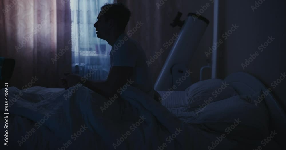 Bad sleep, man abruptly wake up in his bed at the night