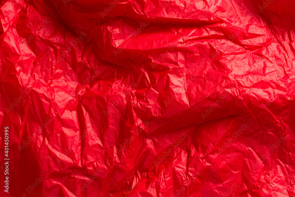 Bright red wrapping paper crumpled paper texture. Creased sheet background. Textured effect. Bright red wrapping paper crumpled paper texture. Creased sheet background. Textured effect.