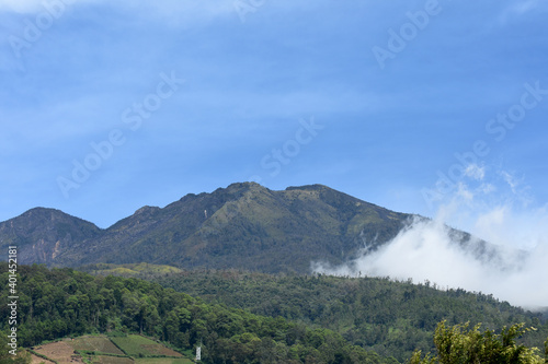 Mount Lawu seen from the Sarangan lake with a beautiful blue sky in Magetan, East Java, Indonesia photo