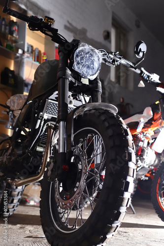 dark motorcycle racing bike with studded wheels