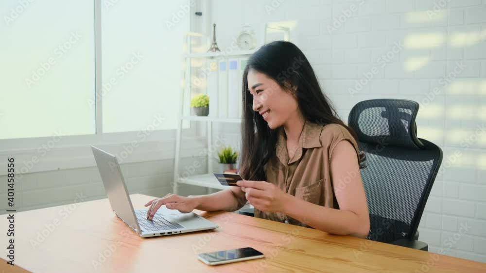 Beautiful woman holding credit card using laptop computer, online shopping with cash back, discount sales, low prices, saving money. Money back concept. Portrait of happy asian freelancer at workplace Beautiful woman holding credit card using laptop computer, online shopping with cash back, discount sales, low prices, saving money. Money back concept. Portrait of happy asian freelancer at workplace