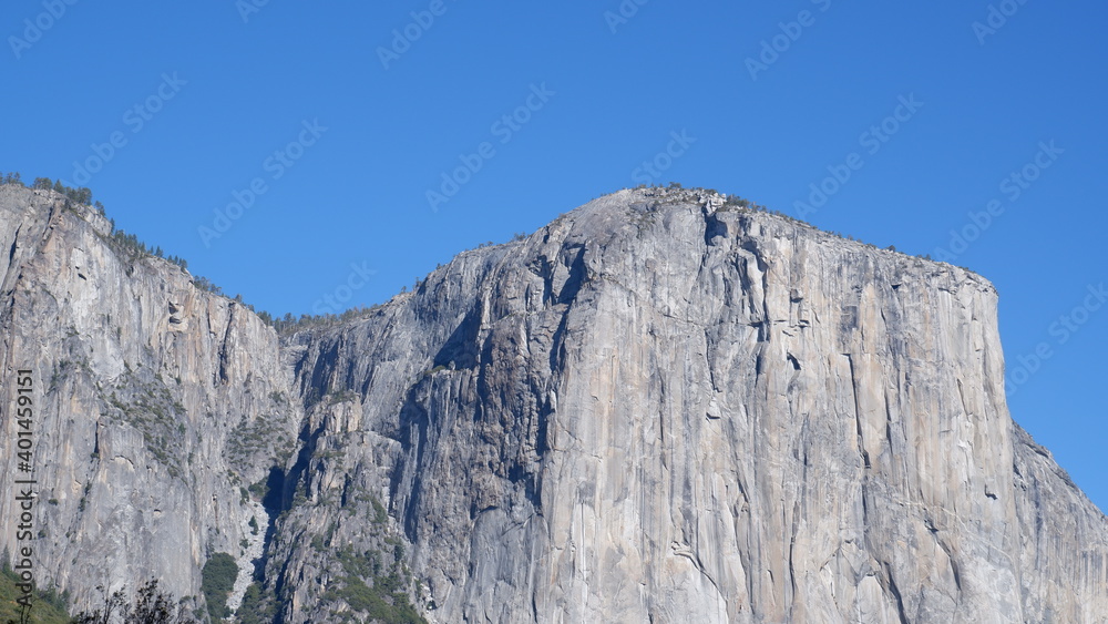 El Capitan Mountain landscape with sky, trees and clouds