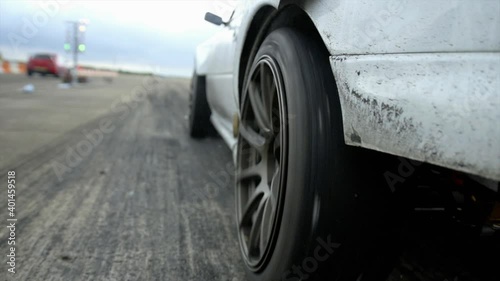 Hard drag car launch spinning tires off the start line! You can see raw fuel puffing from exhaust tip before the tires stat to spin! 

1080P 25FPS 10Bit SLOG2-REC709 photo