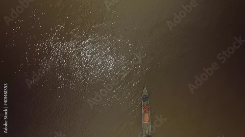 From the top view of an indigenous canoe crossing the frame in the Orinoco River photo