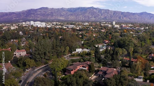 Low aerial panning shot of Pasadena with mountains in the background. HD at 60 FPS. photo