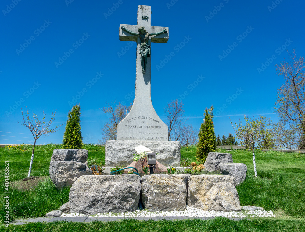 Tombstones and Cross at the St. Patrick Irish Catholic Church cemetery constructed in 1830 in Brampton, Ontario, Canada.