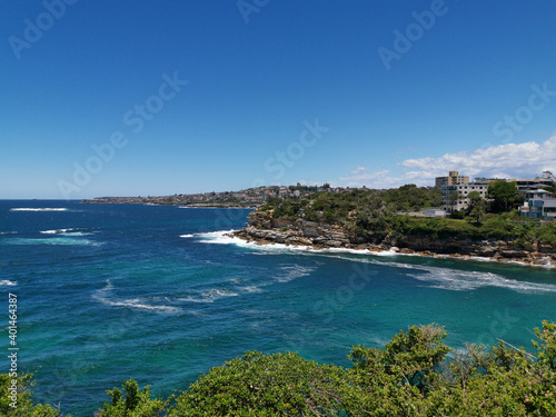 Stunning view of a deep blue sea and small beach from a coastal trail lookout, Sydney, New South Wales, Australia  © Ivan