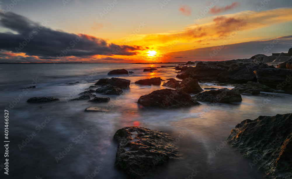 Rocky sea coast at sunrise, long exposure