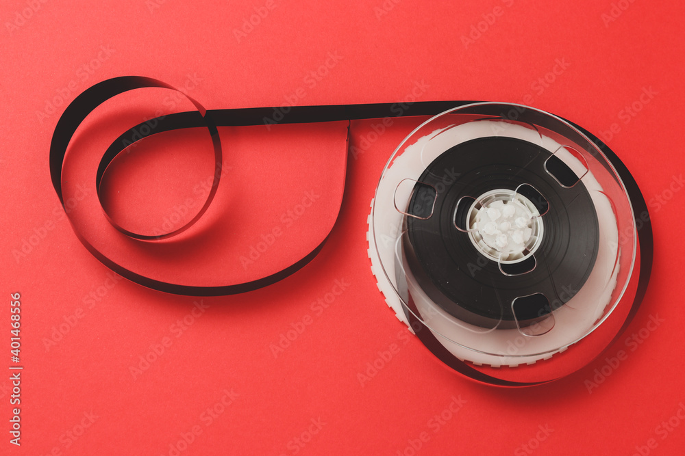 Naklejka premium Roll of Film. Tape roll with red background