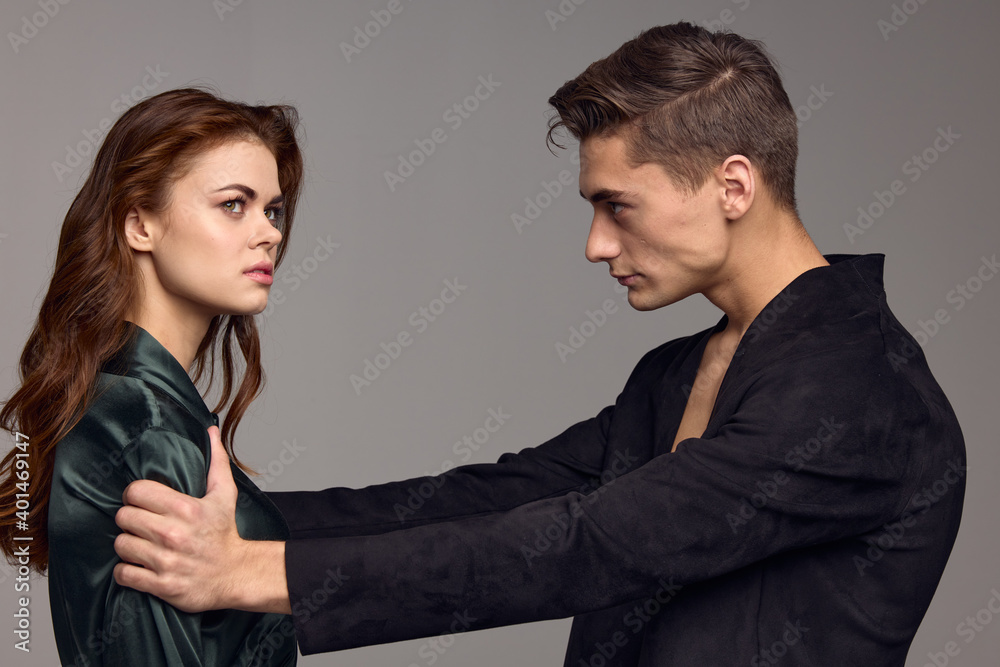 A man holds a woman by the shoulders and friends and communication conflict