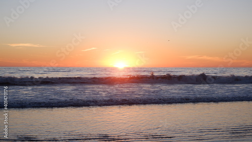 Sunset and ocean waves with birds