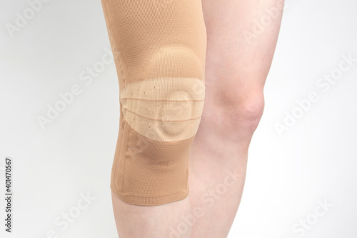 bandage for fixing the injured knee of the human leg on a white background. medicine and sports. limb injury treatment