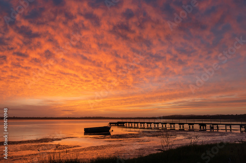 Red sky at dawn on the lake side.