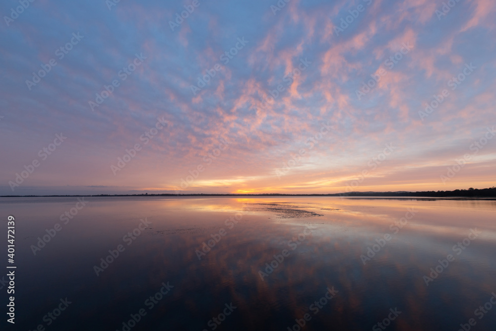 Colorful sunrise sky with reflection on the lake.