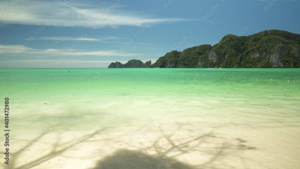 Sunny day on the beach, shadow of tree on ripple wave with seascape Phi Phi island, Krabi, Southern of Thailand, Andaman sea in summer season Sunny day on the beach, shadow of tree on ripple wave with seascape Phi Phi island, Krabi, Southern of Thailand, Andaman sea in summer season