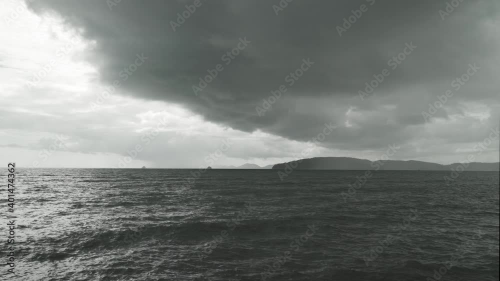 Raining and Dark huge cloud sky black stormy over island and sea, Strong wind, Inclement weather in ocean, Tropical storm in ocean Raining and Dark huge cloud sky black stormy over island and sea, Strong wind, Inclement weather in ocean, Tropical storm in ocean