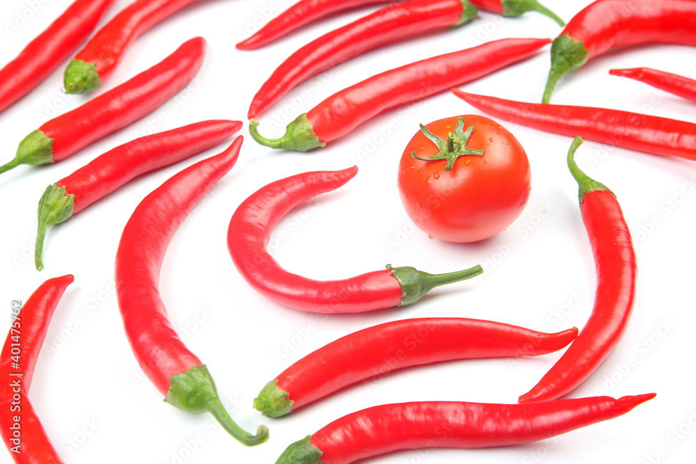Red hot chili peppers and tomato over white background. Vitamin vegetable food Red hot chili peppers and tomato over white background. Vitamin vegetable food
