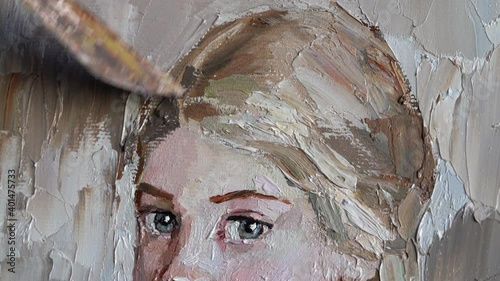 Close up portrait of oil painting. Female artist hand holding palette knife and oil painting drawing. photo