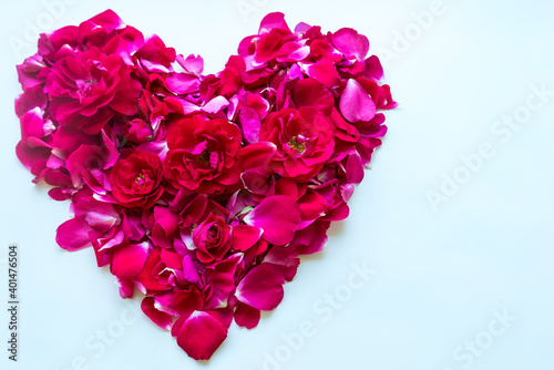Mockup of red roses in the shape of a heart on a white background with copy space 