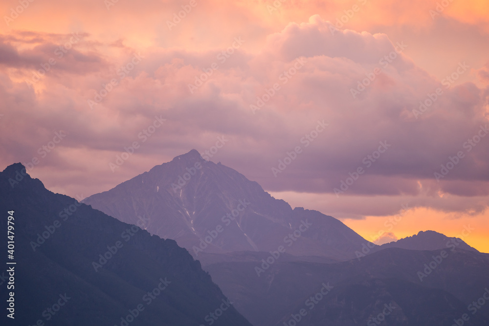 Landscape of mountain peaks in sunset colors