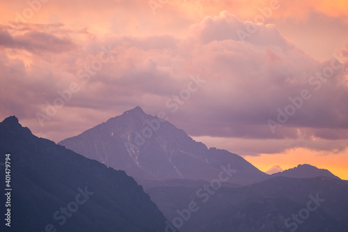Landscape of mountain peaks in sunset colors
