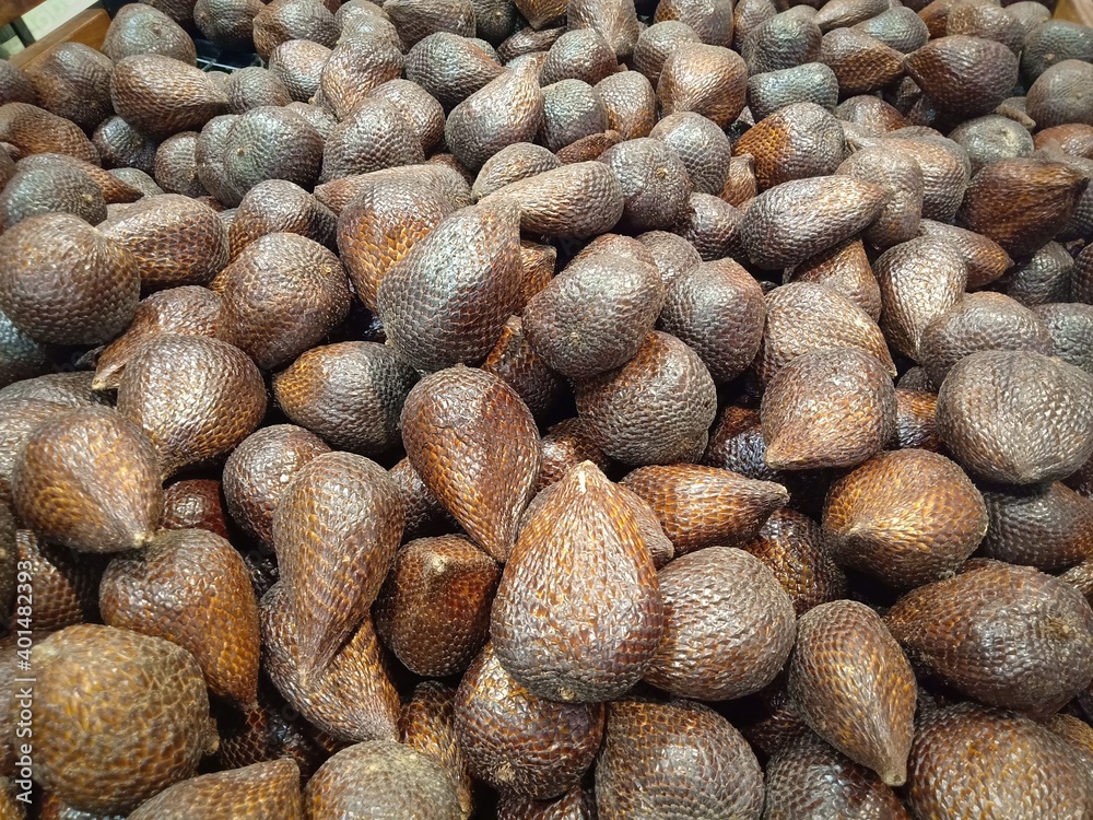 Salak fruit (Salacca zalacca) sell in the market. Salak fruit in market. Salak fruit background. Salak is sweet and sour fruit Salak fruit (Salacca zalacca) sell in the market. Salak fruit in market. Salak fruit background. Salak is sweet and sour fruit