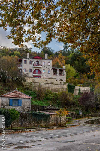 Traditional architecture  in a narrow  stone street during  fall season in the picturesque village of aspraggeloi in Epirus zagori greece photo